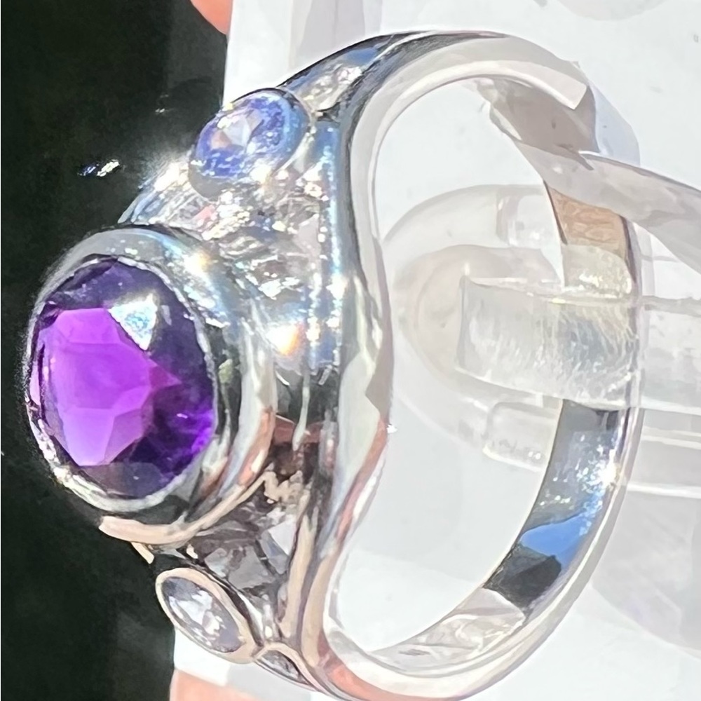 Ring- Rhodium Over
Sterling Silver 
1.13 CTW Amethyst
0.14 CTW Tanzanite 
Size 7